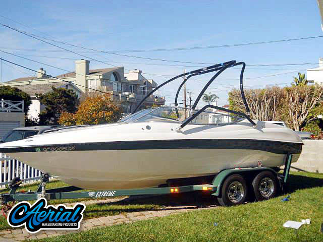 Customer photo of their boat with installed Aerial universal wakeboard tower, speakers, racks, bimini and wakeboard accessories